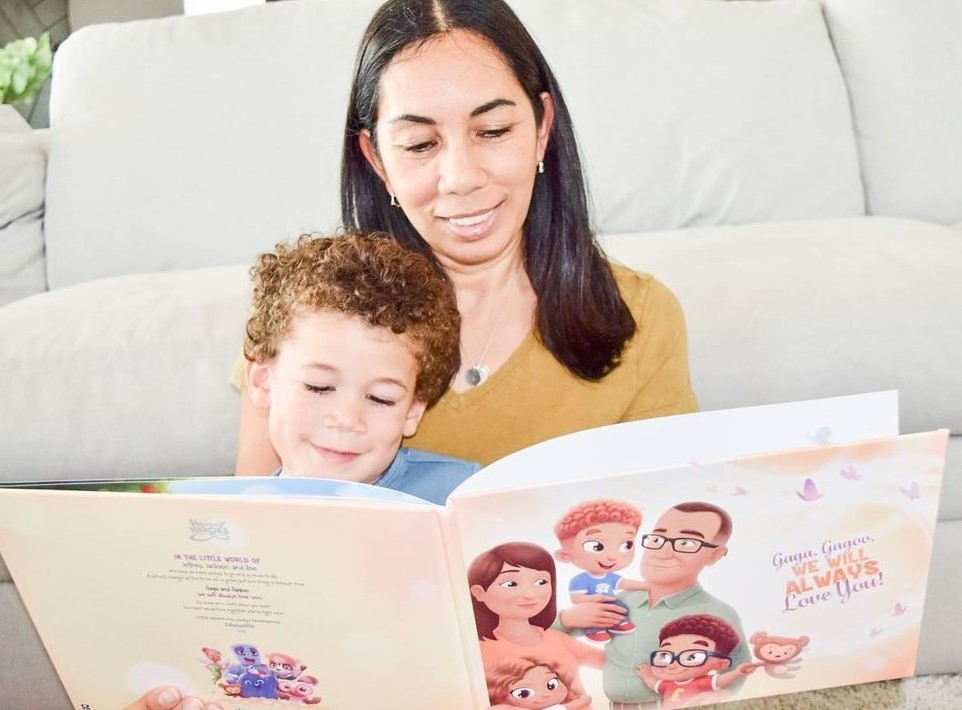 A grandmother reading a Hooray Heroes personalised book for grandparents and up to three grandchildren to her grandson.