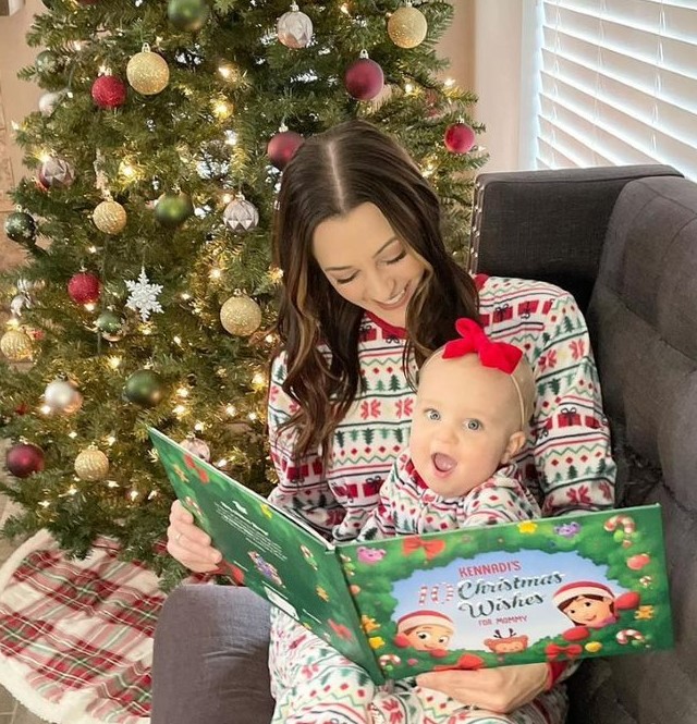 A mother reads a Hooray Heroes personalised Christmas book to her daughter, the perfect xmas gift.